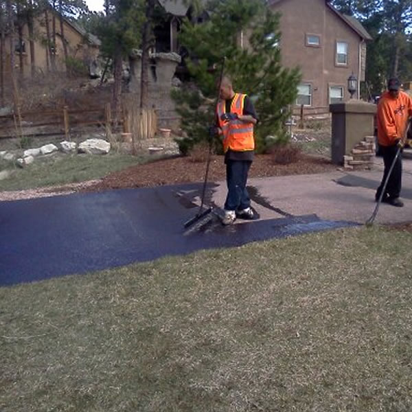 Wide residential asphalt driveway with apron